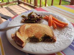 fancy grilled cheese on a plate with carrots and five been salad