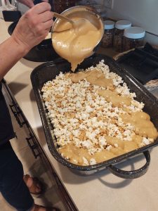 stirring caramel into popcorn